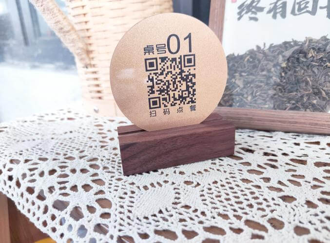 QR code mounted on wall next to table number